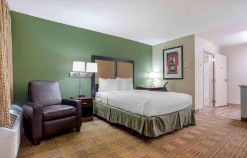 a hotel room with a bed and a chair at Extended Stay America Suites - Huntsville - US Space and Rocket Center in Huntsville