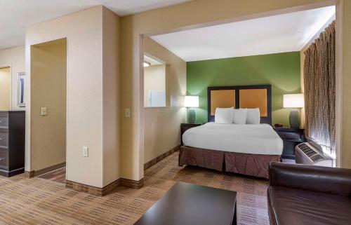 a hotel room with a bed and a couch at Extended Stay America Suites - San Antonio - Colonnade - Medical in San Antonio