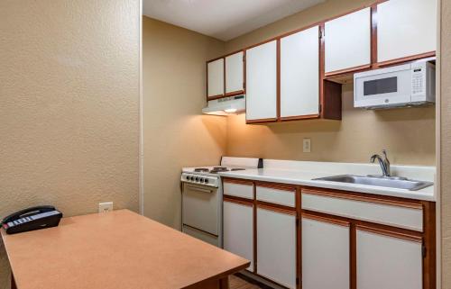 a small kitchen with a sink and a stove at Extended Stay America Suites - San Antonio - Colonnade - Medical in San Antonio