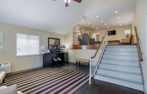a living room with a staircase and a stair case at Extended Stay America Suites - Birmingham - Wildwood in Birmingham