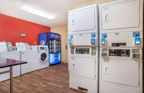 a laundry room with white washers and dryers at Studio 6 Suites Jackson Ridgeland MS in Ridgeland