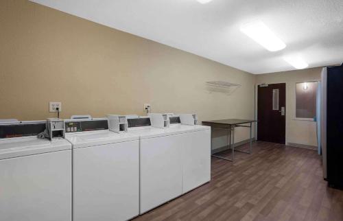 an empty room with white cabinets and a table at Extended Stay America Suites - Houston - Med Ctr - Greenway Plaza in Houston