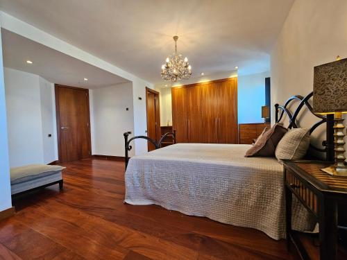 a bedroom with a bed and a chandelier at Mirador La Jirafa - 638A in Oviedo