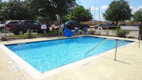 a large swimming pool in a parking lot at Extended Stay America Suites - Houston - Sugar Land in Sugar Land