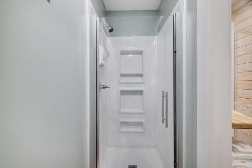 a white shower with shelves in a bathroom at Camptel Poconos in Albrightsville