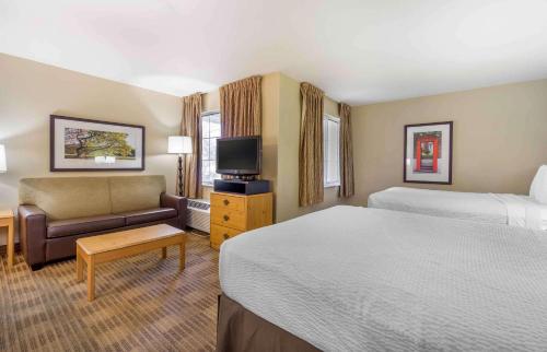a hotel room with a bed and a couch at Extended Stay America Suites - Seattle - Bothell - Canyon Park in Bothell