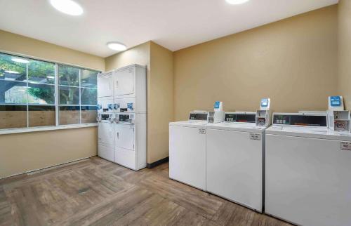 a laundry room with white appliances and a window at Extended Stay America Suites - Seattle - Bothell - Canyon Park in Bothell