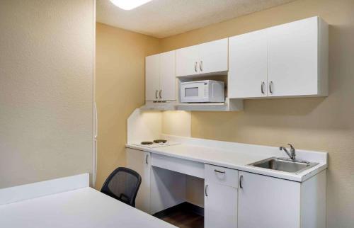 a small kitchen with a sink and a microwave at Extended Stay America Suites - Seattle - Everett - North in Everett