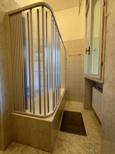 a shower in a bathroom with a window at Sweet home in Bordighera