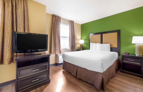 a hotel room with a bed and a flat screen tv at Extended Stay America Suites - Seattle - Everett - Silverlake in Murphys Corner