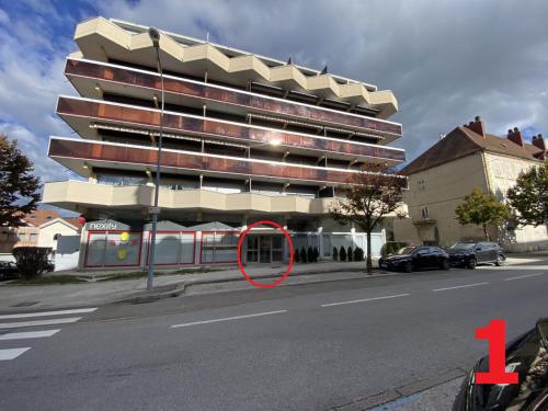 a building on the side of a street with a red circle at Studio Cosy in Pontarlier