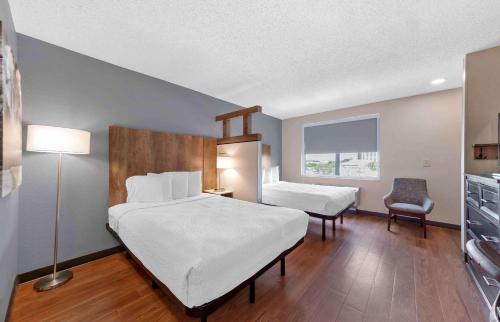 a bedroom with a large bed and a desk and chair at Extended Stay America Suites - Seattle - Redmond in Bellevue