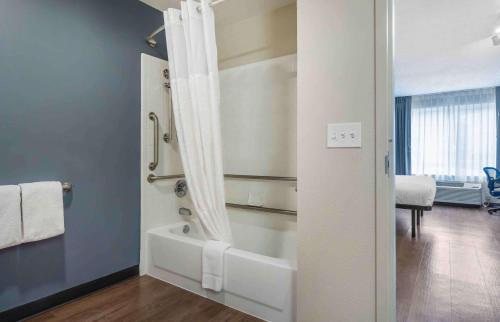 a bathroom with a shower and a bath tub at Extended Stay America Suites - Seattle - Redmond in Bellevue