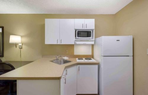 a kitchen with white cabinets and a white refrigerator at Extended Stay America Suites - Seattle - Kent in Kent