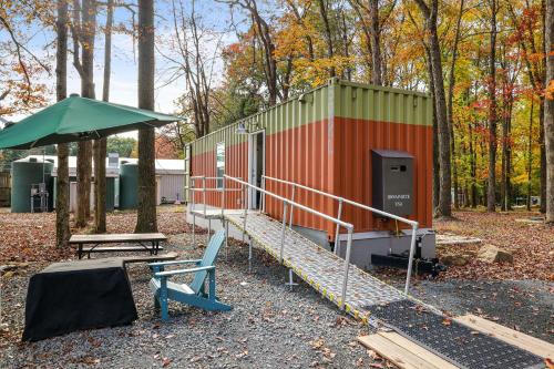 a building with a table and a bench in a park at Camptel Poconos in Albrightsville