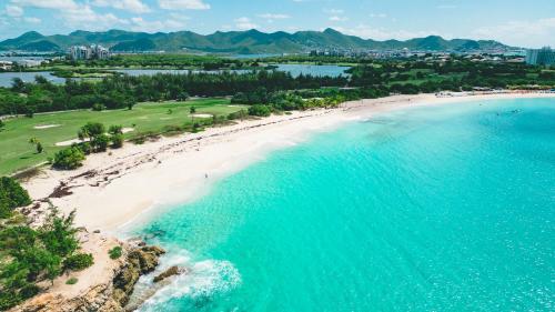 an aerial view of a beach and the ocean at Fourteen at Mullet Bay in Cupecoy