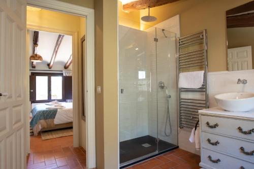 a bathroom with a glass shower and a sink at La Masia Alt Penedès in Pontons