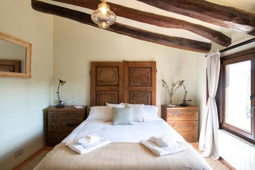 a bedroom with a bed with two towels on it at La Masia Alt Penedès in Pontons