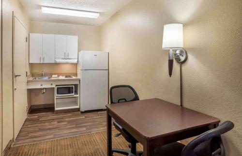 a small kitchen with a table and a refrigerator at Extended Stay America Suites - Nashville - Brentwood - South in Brentwood