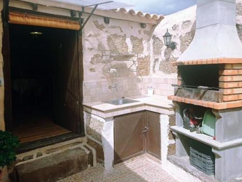 an outdoor kitchen with a sink and a brick wall at Live Arico Lagar in Arico el Nuevo