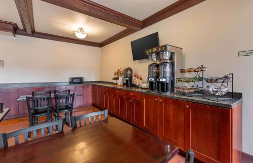 a kitchen with a counter with a bar with stools at Extended Stay Americas Suites - Minot in Minot
