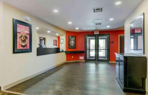 a large room with red walls and a hallway with aiger at Extended Stay America Suites - Phoenix - Airport in Phoenix