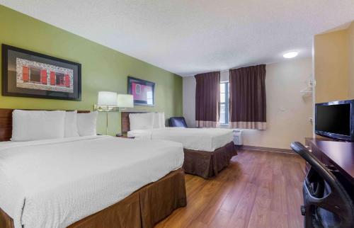a hotel room with two beds and a flat screen tv at Extended Stay America Suites - Phoenix - Airport in Phoenix