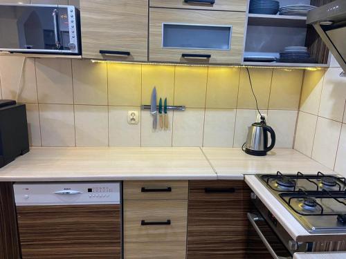 a kitchen with a stove and a counter top at Apartament Skandynawski in Nowe Worowo