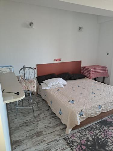 a bedroom with a bed and a table and chairs at Apartament in Chişinău