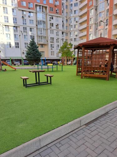 a park with two benches and a gazebo at Apartament in Chişinău