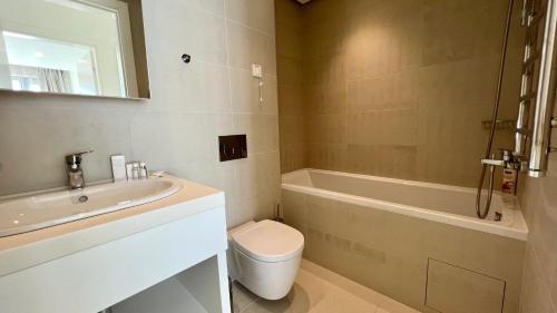 a bathroom with a sink and a toilet and a bath tub at Sunraf Luxe Apartments in Budva