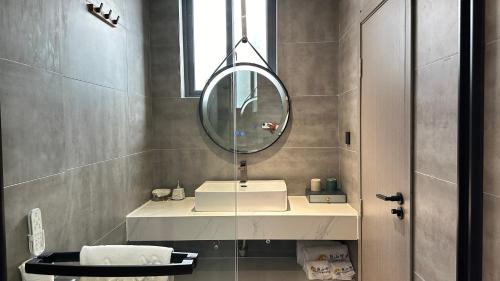 a bathroom with a sink and a mirror at Lanshan Moon Resort in Yangshuo