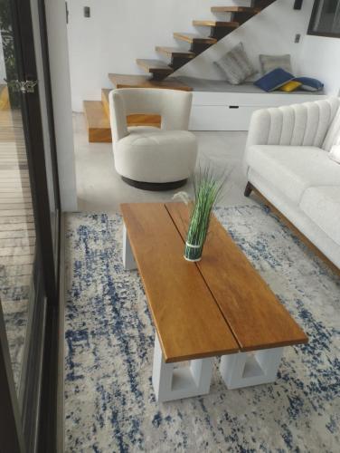 a living room with a coffee table and a couch at Atitlan Sunset Lodge in Santa Cruz La Laguna