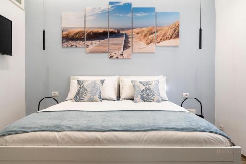 a boardwalk to the beach multi panel canvas wall art at Dolci Coccole Small Suite a Bari città! in Bari