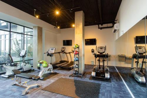 a gym with several treadmills and machines in a room at Balcony,gym,rooftop Grill,terrace, Kingbed, 4k Tv in Tacoma
