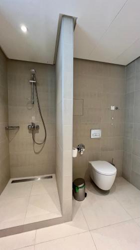 a bathroom with a shower and a toilet in it at Sunraf Luxe Apartments in Budva
