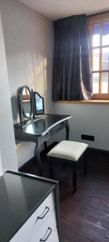 a desk with a mirror and a chair in a room at Villa Hortensia in Bagnères-de-Bigorre