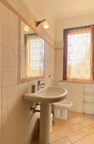 a bathroom with a sink and a toilet at Villa Toscagialla in San Vincenzo