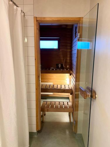 a walk in shower in a bathroom with a glass door at Star of Annala in Tampere