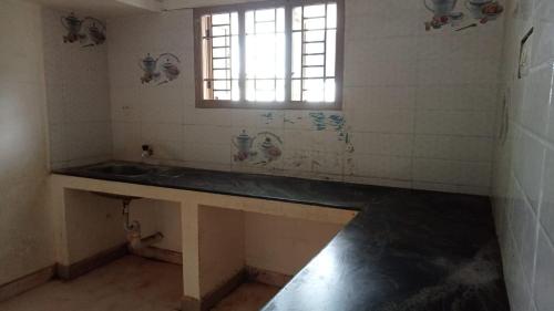 a bathroom with a sink and a window at Hallima Home Stay Services Golden Nagar in Pudukkottai