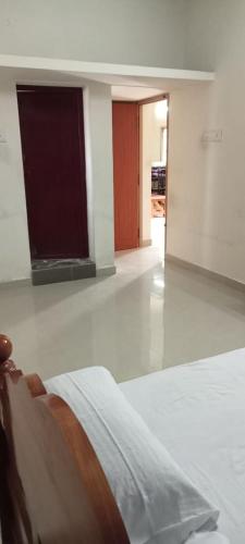a bedroom with a bed and a room with a hallway at Hallima Home Stay Services Golden Nagar in Pudukkottai
