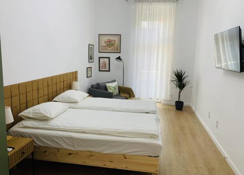 a bedroom with a large bed in a room at Margaret Boulevard Apartment - with balcony in Budapest
