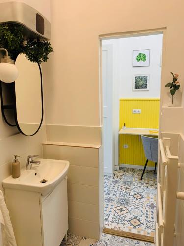 a bathroom with a sink and a desk at Margaret Boulevard Apartment - with balcony in Budapest