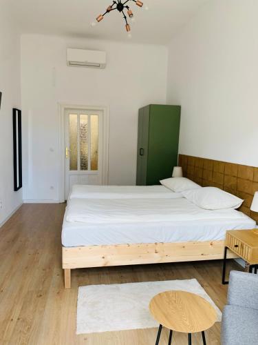 a bedroom with a large bed and a couch at Margaret Boulevard Apartment - with balcony in Budapest