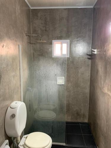a bathroom with a toilet and a glass shower at Punta Cocos 