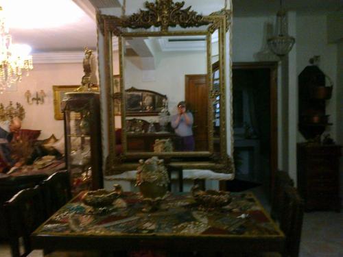 a woman taking a picture in front of a mirror at Laraqui hossini in Fez
