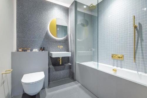 a bathroom with a toilet and a sink and a shower at ShySuite 1BED in London
