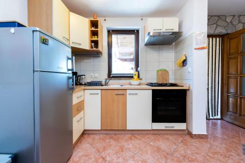 a kitchen with a refrigerator and a sink at House Poljica with a pool in Poljica