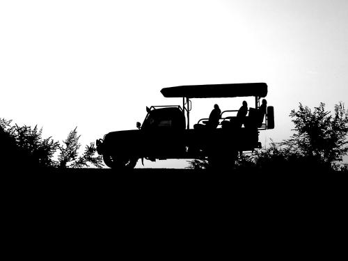a group of people riding on a tractor at Leel’s Safari Cottage in Udawalawe