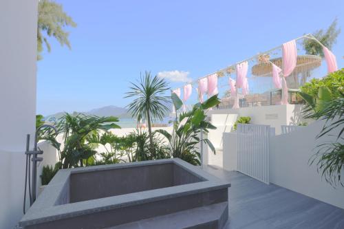 a balcony with a bench and palm trees on it at Shenzhen Semporna Beach Sea View B & B - 深圳较场尾仙本那沙滩海景民宿 in Shenzhen